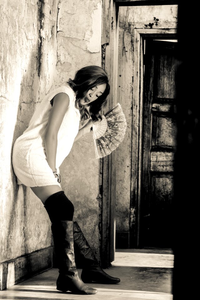 Grayscale Photography Of Woman Leaning On Wall photo