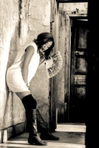 Grayscale Photography Of Woman Leaning On Wall photo