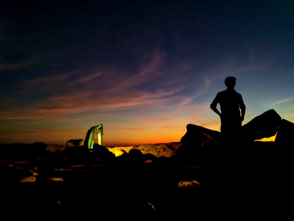 Silhouette Photo Of Person Standing Near The Rock
