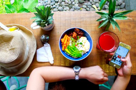 Woman Holding Iphone While Eating