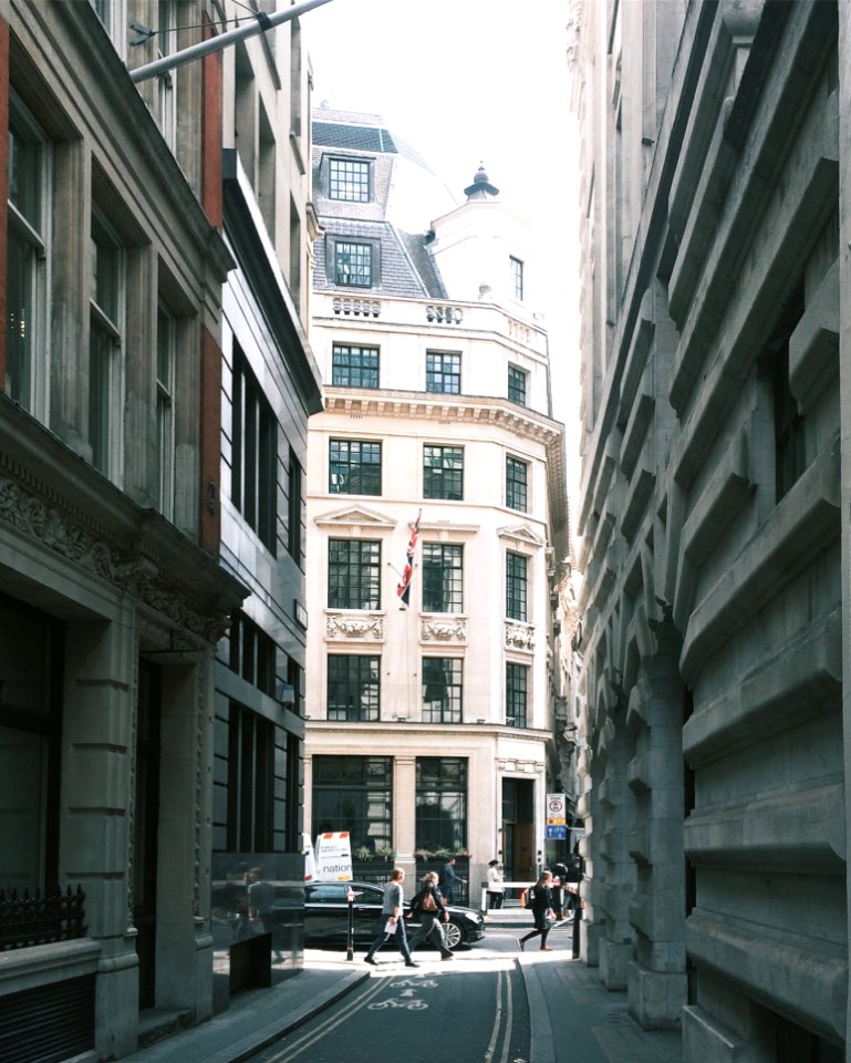 People Walking Near Building And Cars