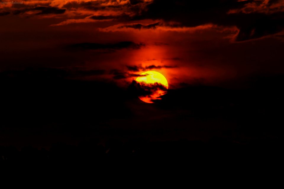 Orange Sun Hiding On Clouds