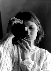 Grayscale Photography Of Woman Holding Camera photo