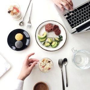 Photo Of White Plate Beside Macbook