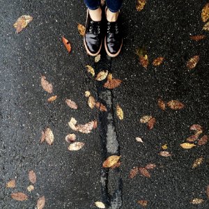 Person Wearing Black Low-top Shoes Standing Concrete Pavement photo