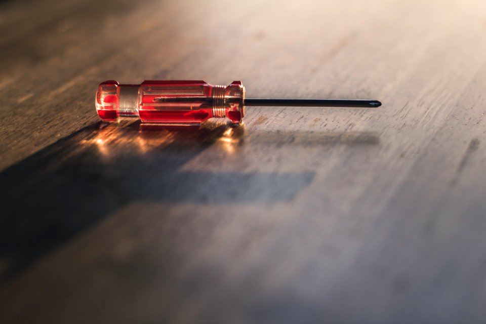 Red Driver On Brown Wooden Surface
