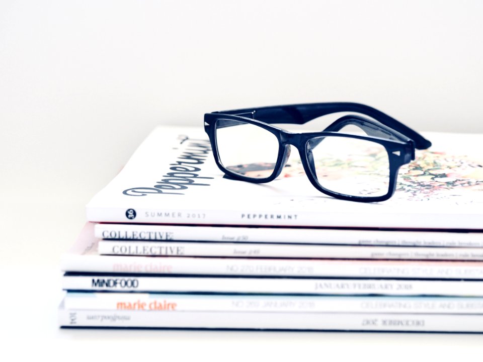 Black Framed Eyeglasses On Seven Collective Books photo