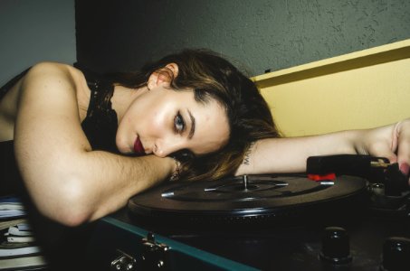 Woman Wearing Black Top Lying On Turntable photo