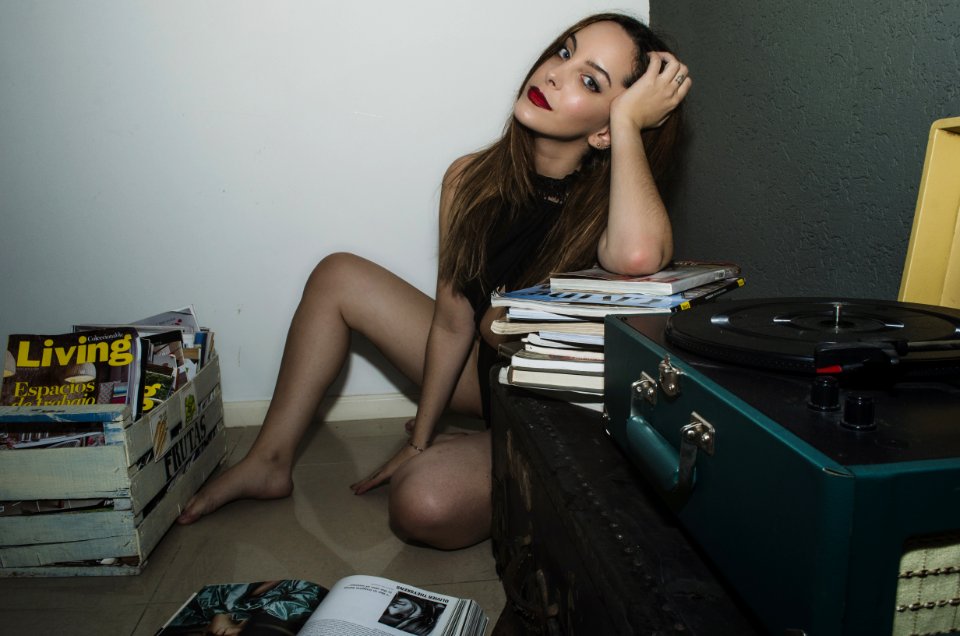 Woman Sitting On Floor Surrounded By Books