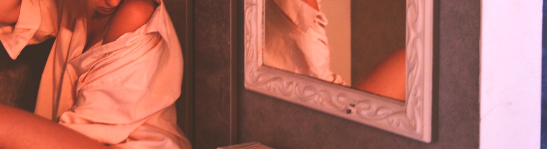 Woman Wearing White Top Near Mirror With White Wooden Frame photo