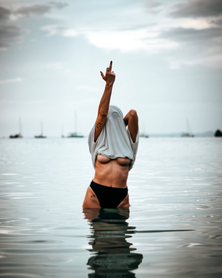 Woman Wearing White Shirt Raise His Middle Finger