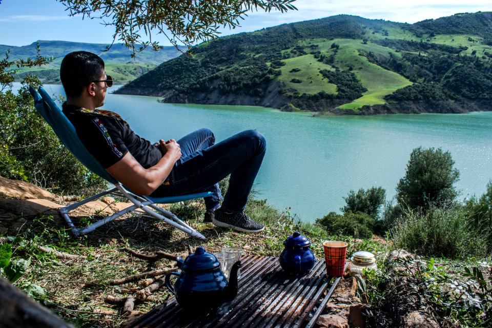 Man Sitting Overlooking Lake