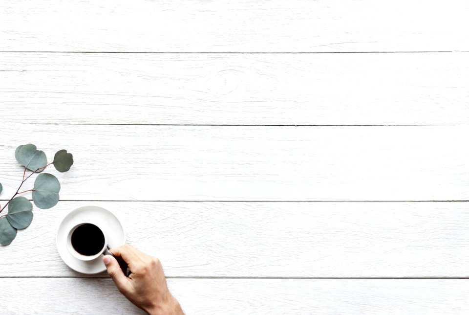 Person Holding White Ceramic Teacup With Black Coffee photo