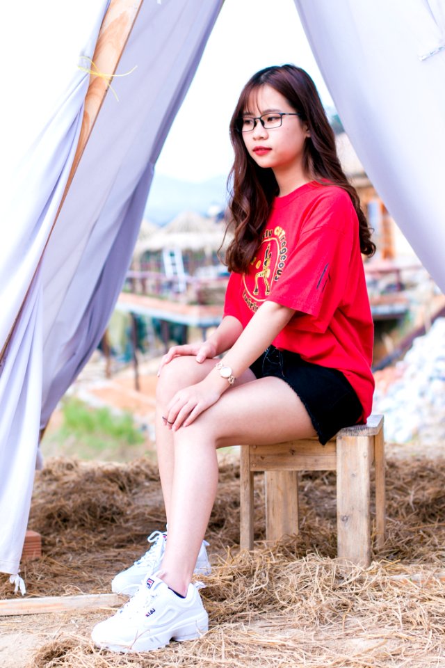 Woman In Red T-shirt And Black Denim Shorts