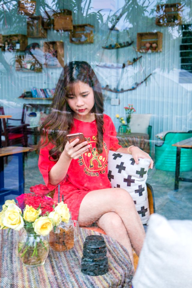 Woman Using Smartphone Sitting On Chair