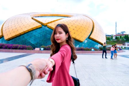 Woman Wearing Pink Long-sleeved Dress Holding Persons Hand photo