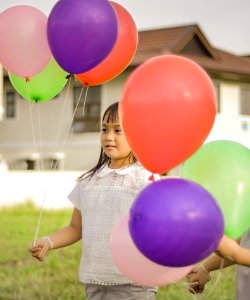 Photography Of A Girl Holding Balloons