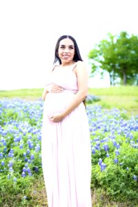 Pregnant Wearing Pink Dress Surrounded With Lavender photo