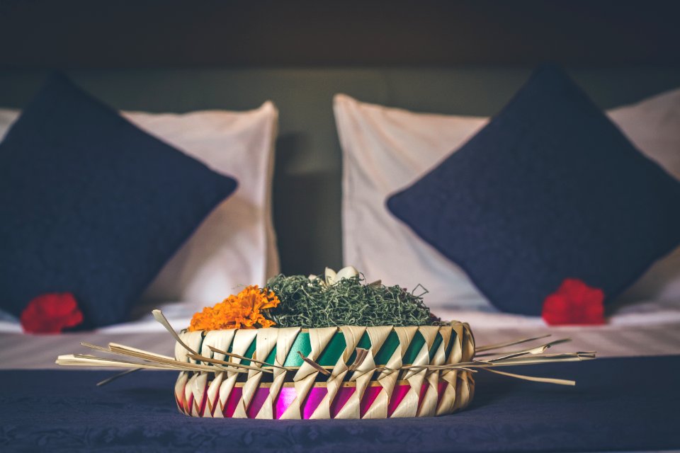 White And Green Table Decoration Near Two Black Pillows