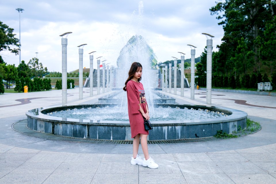 Woman Wearing Pink Crew-neck Long-sleeved Midi Dress Standing Concrete Outdoor Fountain