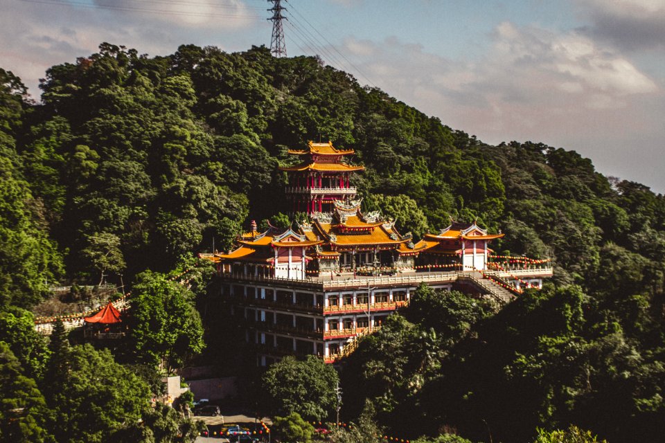 Orange Concrete Building Surrounded By Green Trees At Daytime