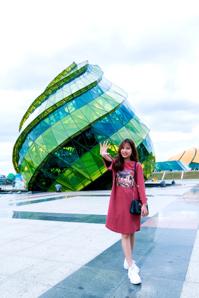 Woman In Front Of Green Glass Building