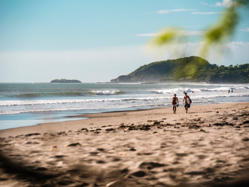 Two Person Walking On Beachside