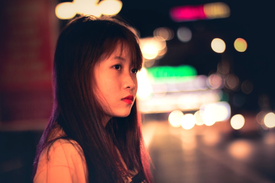 Woman Wearing Beige Tops And Bokeh Light photo