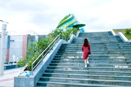 Woman Wearing Red Dress On Gray Stairs photo