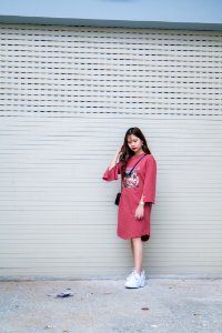 Woman In Pink Long-sleeved Midi-dress And Pair Of White Shoes