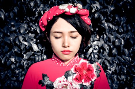 Woman With Her Eyes Closed Wearing Pink Floral Top photo