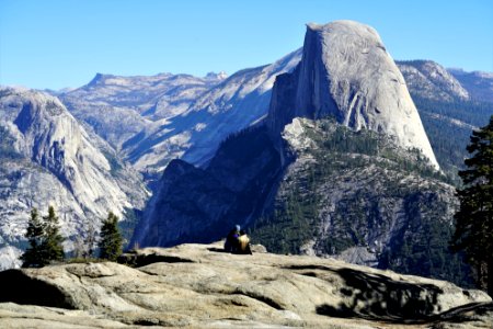Two People Sitting On Mountain Edge photo