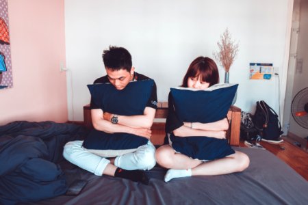 Man And Woman Sitting On Bed photo