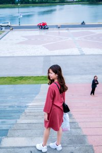 Woman Wearing Red Clothes And Pair Of White Running Shoes
