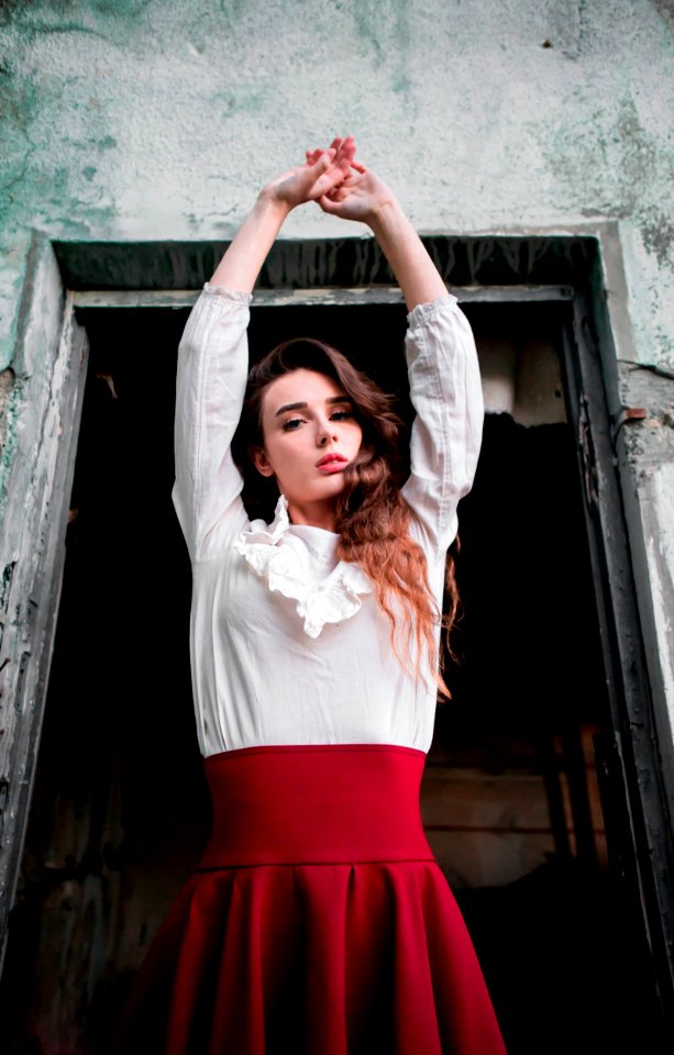Woman Wearing White And Red Dress Raising Her Hands Up