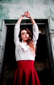 Woman Wearing White And Red Dress Raising Her Hands Up