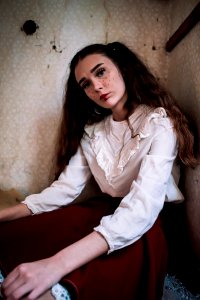 Brown Haired Woman Wearing White Long-sleeved Shirt And Red Skirt photo