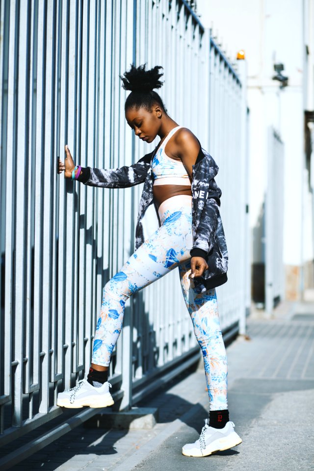 Woman Wearing White And Blue Pants And Pair Of Gray-and-white Low-top Sneakers