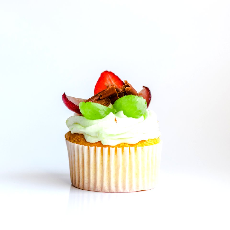 White And Yellow Cupcake With Fruit Toppings