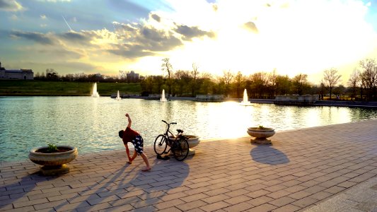 Man Standing Near Bicycle And Body Water photo