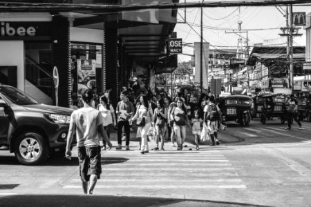 Monochrome Photography Of People Crossing The Road