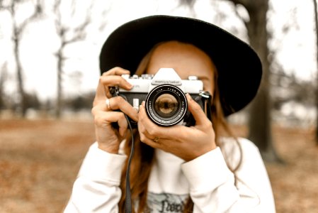Selective Focus Photography Of Woman Using White And Black Slr Camera photo