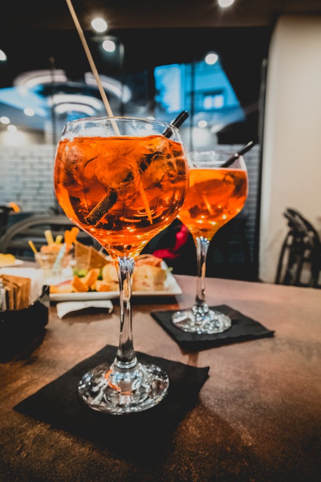 Two Clear Wine Glasses With Straws