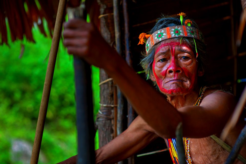 Selective Focus Photography Of Man Holding Stick Wearing Headband