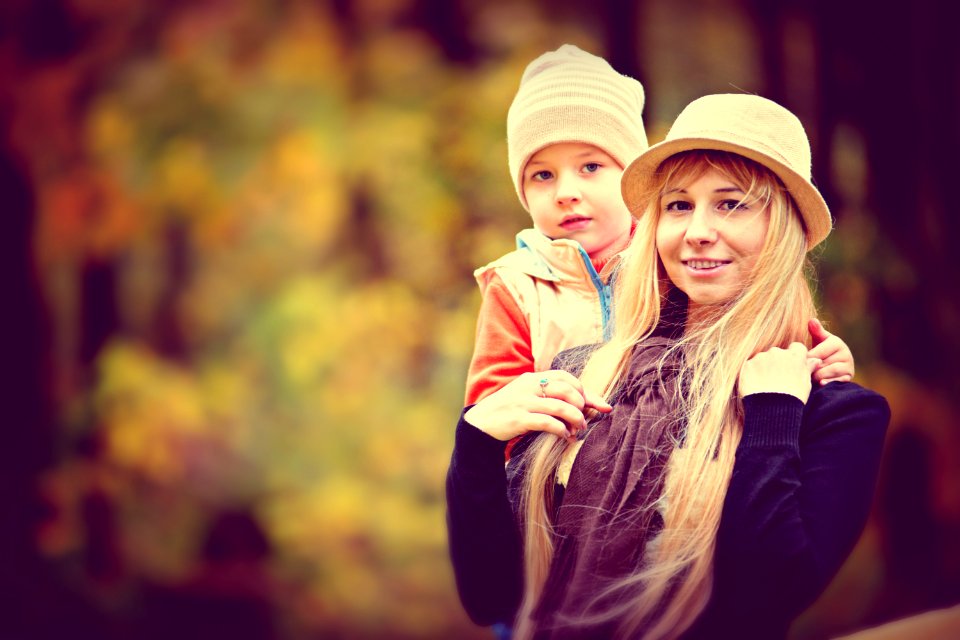 Shallow Focus Photo Of A Woman Carrying A Toddler