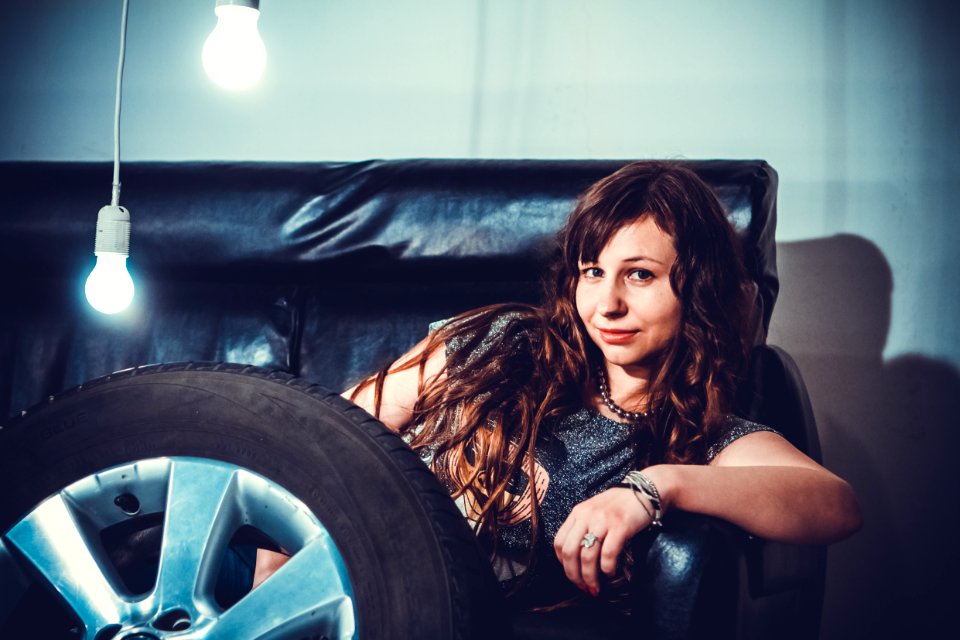 Photo Of Woman Sitting On Couch Front Of Wheel