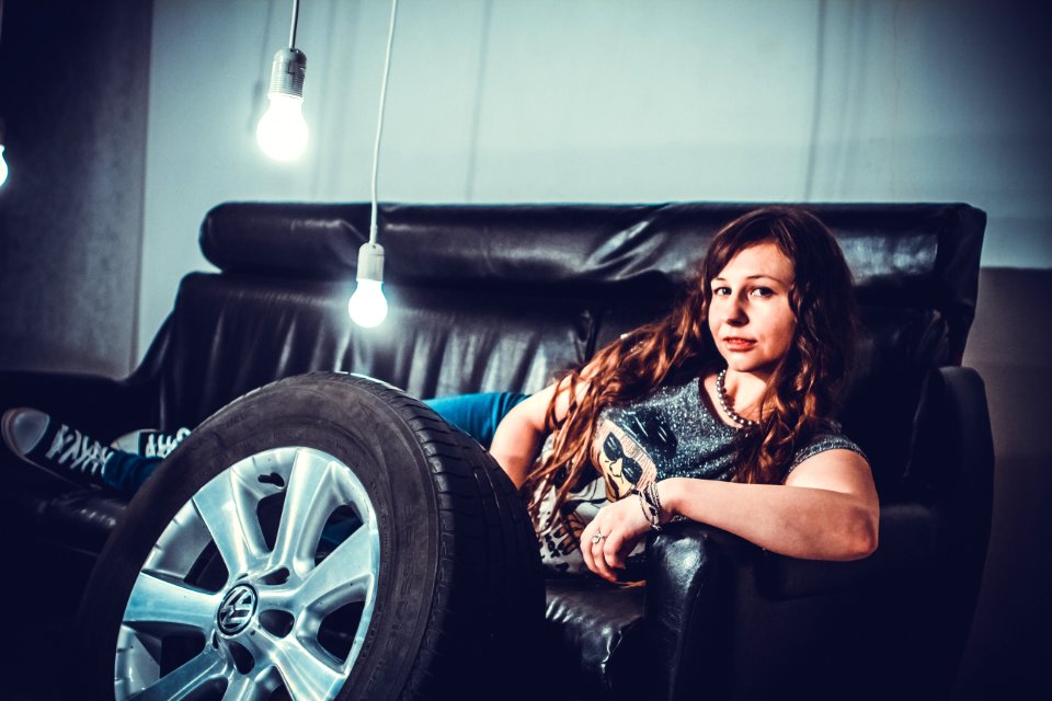 Woman Lying In Black Leather Couch