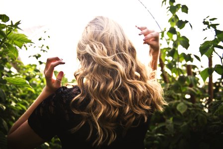 Blonde-haired Woman Standing Between Green Plants