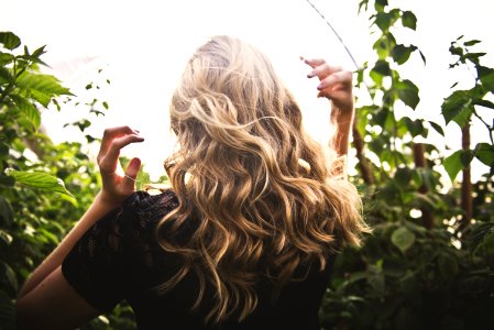 Blonde-haired Woman Standing Between Green Plants photo