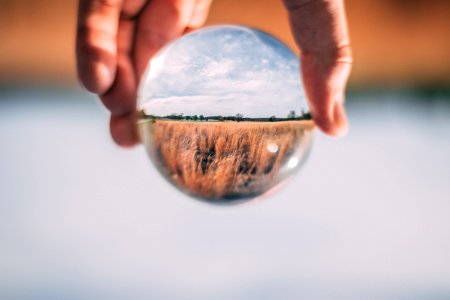 Photo Of Person Holding Clear Glass Ball